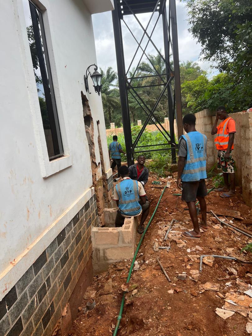 Team installation work around the exterior of a developing property.