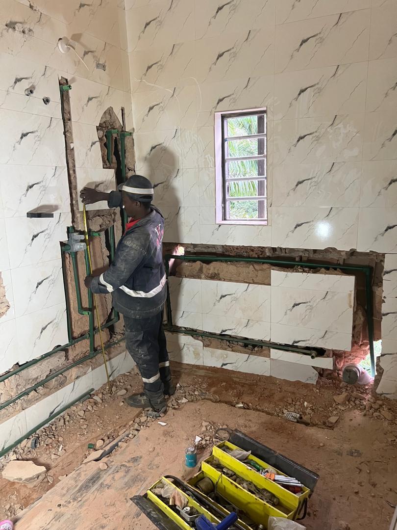 DYP technician measuring the installation area before pipework begins