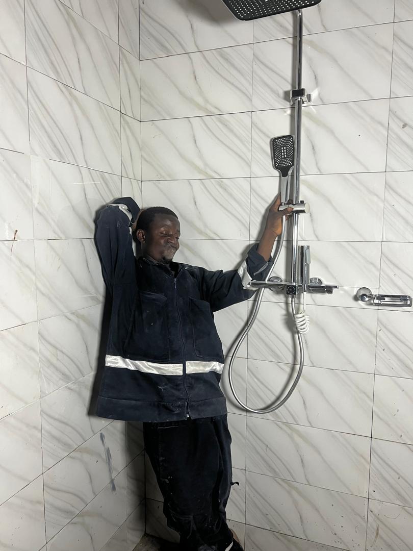 DYP technician installing shower fittings in a tiled bathroom